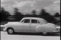 GM CAR ON RURAL ROAD - 4 - 1950s - Film & Video Stock