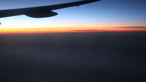 AIRPLANE WING AGAINST SUNSET SKY - POV - HD - Film & Video Stock